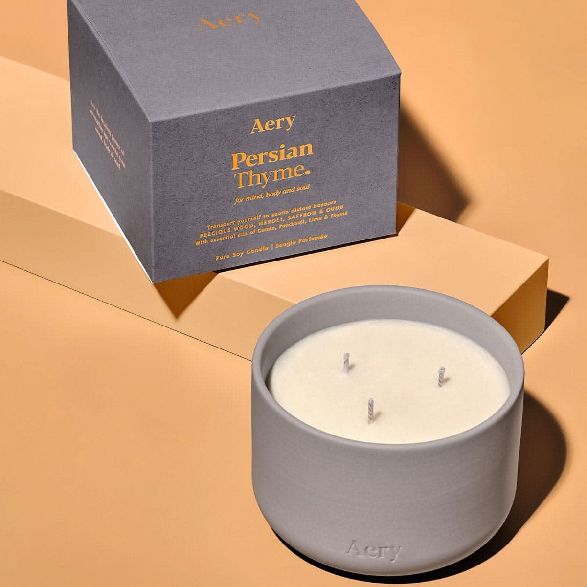 Aery clay pot triple wick persian thyme candle with packaging on a white background