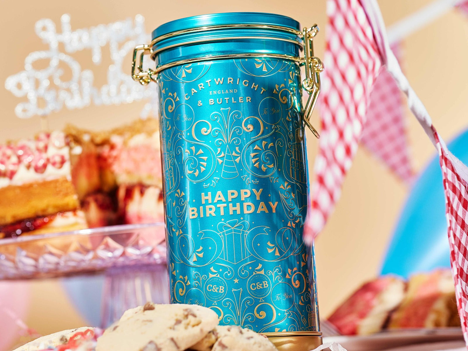 Cartwright & Butler 'Happy Birthday' cookie tin with a cookie on a white background
