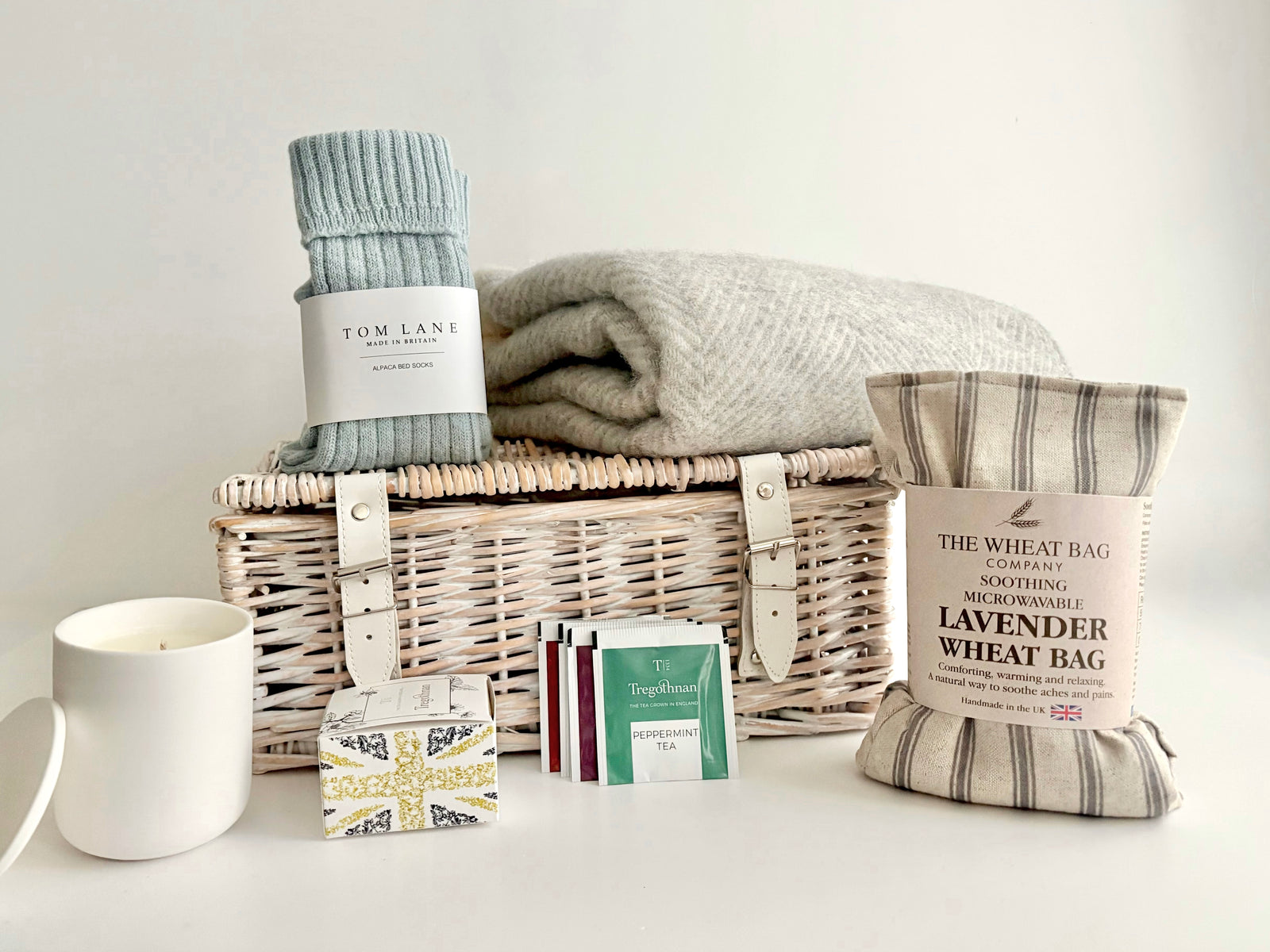 The Cosy Hamper Self Care luxury gift hamper basket with Herringbone Blanket, alpaca socks, herbal tea, candle and wheatbag