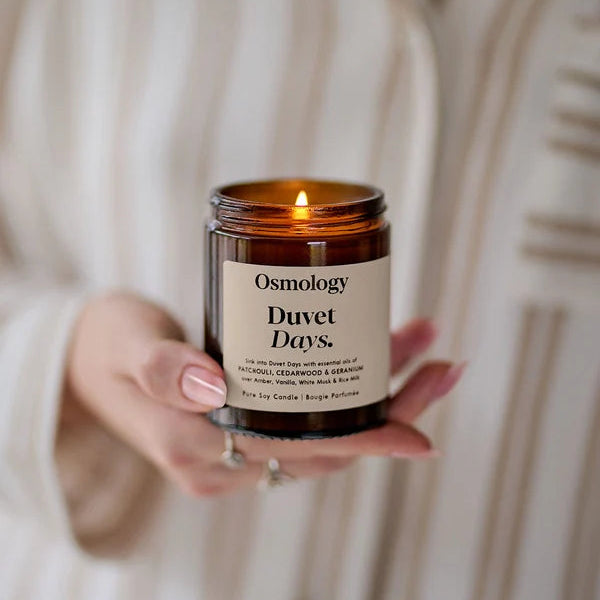 Duvet Days Glass Jar Candle lit held in hand