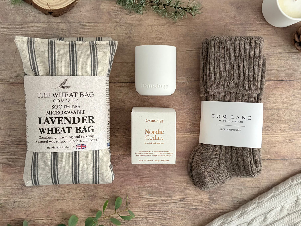 Warm and cosy care package with lavender heatable wheatbag, alpaca bed socks and nordic cedar candle