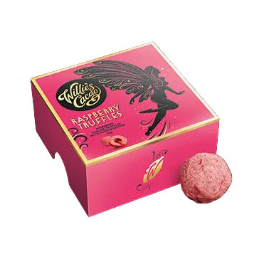 A rectangular pink box of raspberry truffles with a single truffle ball placed in front, featuring the brand 'Willie's Cacao' and a graphic design that includes a fairy and raspberries.